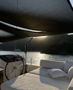 the sun shines brightly through the sails of a boat