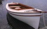 a small white boat floating on top of a body of water