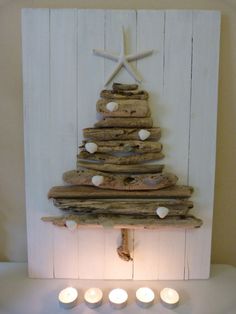 a christmas tree made out of driftwood with candles