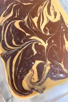 chocolate and peanut butter swirled on top of each other in a baking dish with icing