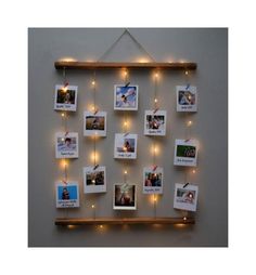 a wooden shelf with pictures hanging from it's sides and some lights on the wall