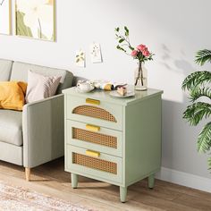 a living room with a couch, table and potted plant on the sideboard