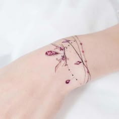 a woman's arm with pink flowers on it