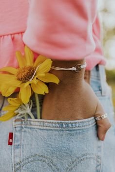 a person with a yellow flower in their back pocket