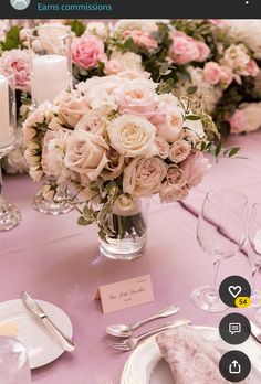 the table is set with pink and white flowers