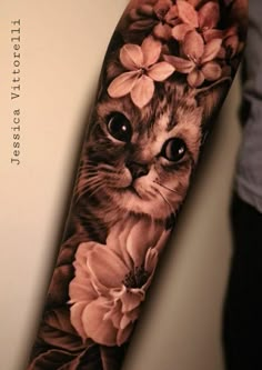 a cat with flowers on it's arm