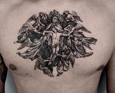 a man's chest with an angel and demon tattoo on his chest is shown