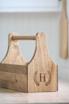 a wooden toy with the letter h on it's side and a bottle in the background