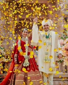 the newly married couple are posing in front of confetti