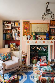 a living room filled with furniture and a fire place in front of a book shelf