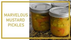 three jars filled with pickles sitting on top of a counter