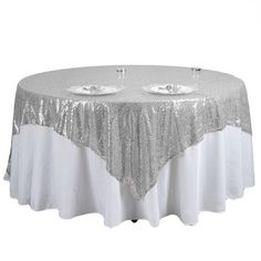 silver sequin tablecloth with two plates on it