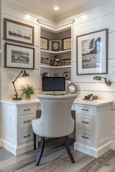 a home office with white furniture and pictures on the wall, along with a computer desk