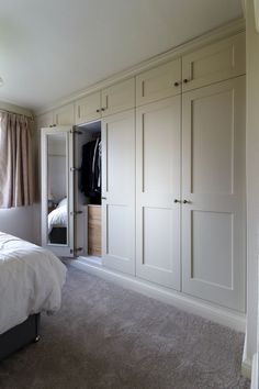 a bedroom with a bed and closets in it