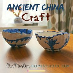 two blue and white bowls sitting on top of a wooden table