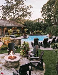 an outdoor fire pit with chairs around it