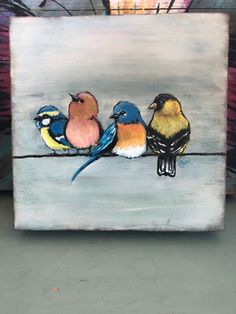 three birds are sitting on a wire painted with acrylic paint