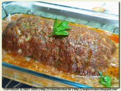 meatloaf covered in sauce and garnished with parsley