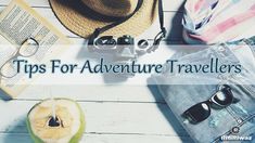 an apple, hat, sunglasses and book on a white wooden table with the words tips for adventure travelers