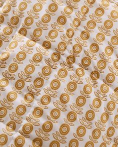 gold and white fabric with circles on it