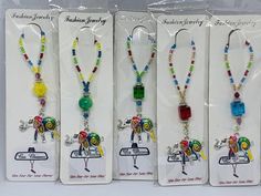 three packaged necklaces with different colored beads and charms on each beaded strander