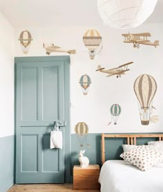 a bedroom with hot air balloons on the wall