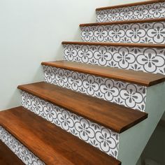 a set of stairs with decorative wallpaper on the riser and handrails