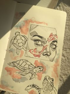 an open book with drawings on it and a drawing of a woman's face