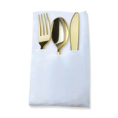 two forks, spoons and an empty napkin on a white tablecloth with gold colored utensils