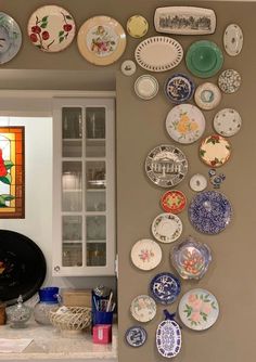 a kitchen counter with plates on the wall