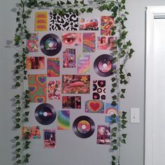 the wall is covered with various records and ivy growing up against it's sides