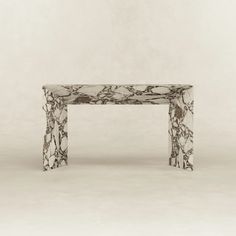 a marbled bench sitting on top of a white floor