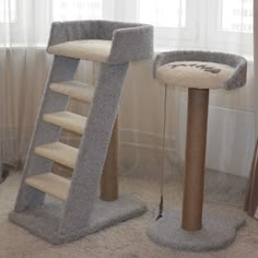 two cat scratching towers in the corner of a living room with carpeted flooring