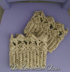 three crocheted gloves sitting on top of a blue chair