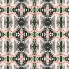 an abstract design with pink and green accents on black fabric, which is also in the background