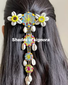 the back of a woman's head wearing a colorful hair comb