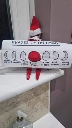 a toilet paper roll with the words phases of the moon on it in front of a bathroom sink