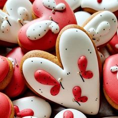 some heart shaped cookies with red and white frosting on them are arranged in the shape of hearts