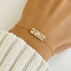 a woman's arm wearing a gold bracelet with the words miss and ms on it