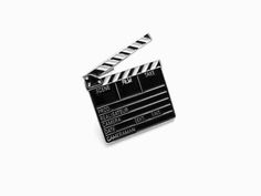 a black and white movie clapper pin on a white background with the word'film tape'written across it