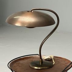 a lamp that is sitting on top of a plate with a saucer underneath it