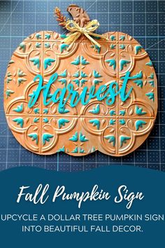 a pumpkin shaped cookie with the words fall pumpkin sign in blue and gold on it