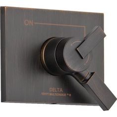 a close up of a black and gold faucet with the delta logo on it