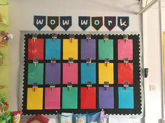 a bulletin board with colorful sticky notes attached to it's sides and hanging on the wall