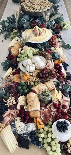 a table topped with lots of different types of cheeses and crackers on top of it