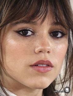 a close up of a woman with brown eyes