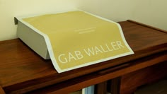 a piece of paper sitting on top of a wooden table with the word gab waller printed on it