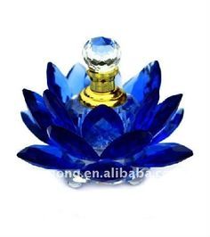 a blue glass flower with a crystal top on it's side, and the bottom is