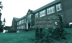 a sign in front of a building that says forks high school home of the spartans