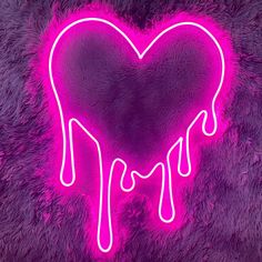 a heart shaped neon sign with drips on purple fuzzy material in the shape of a heart